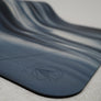 Thick cushioning yoga mat providing extra support for joint protection during exercises.